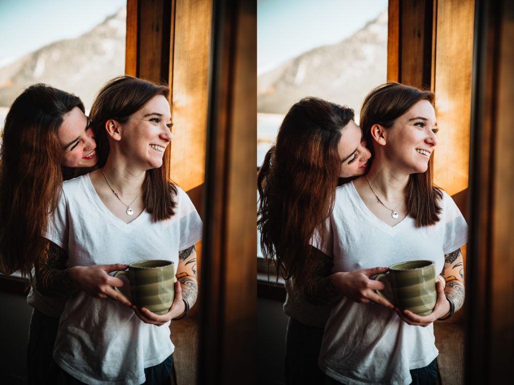 same sex couple sipping coffee by the window