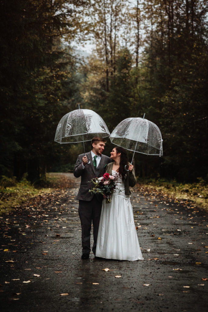 clear umbrellas during a rainy fall elopement in alaska