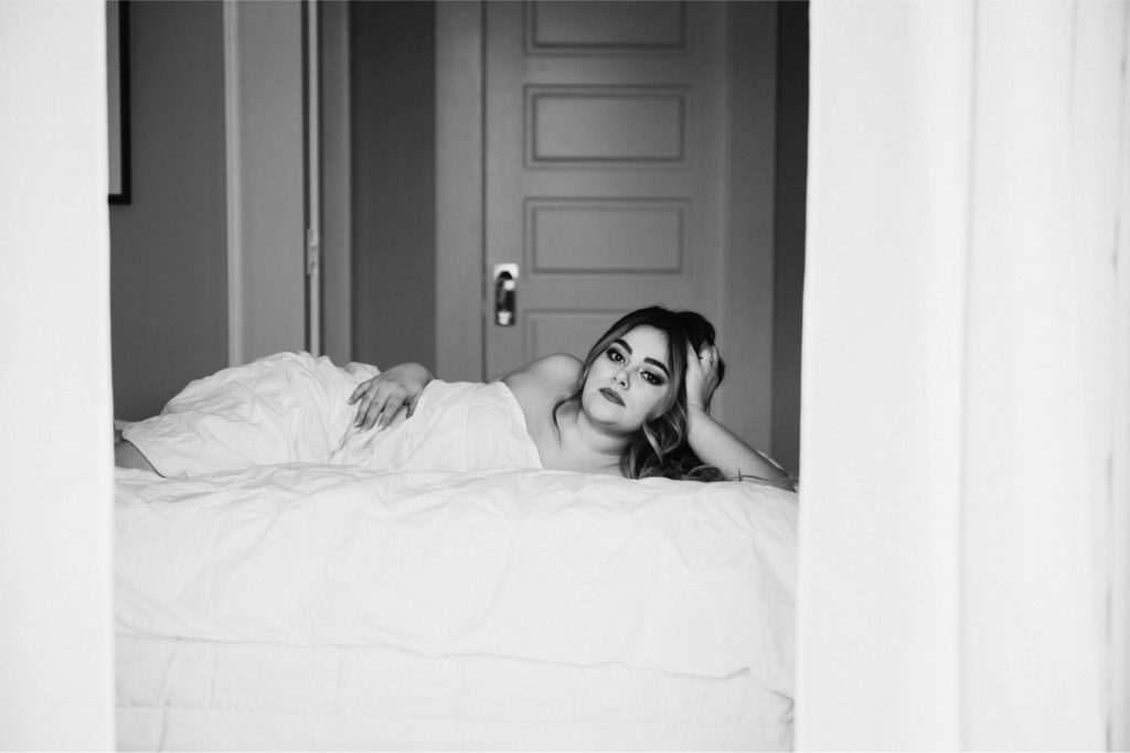 black and white photo of woman in white sheets