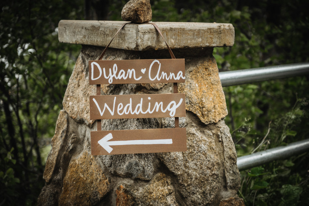 Painted sign for Dylan and Anna's Alaska Beach wedding