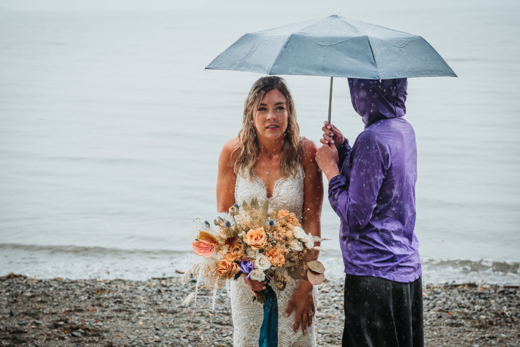 bride under umbrella in the rain
