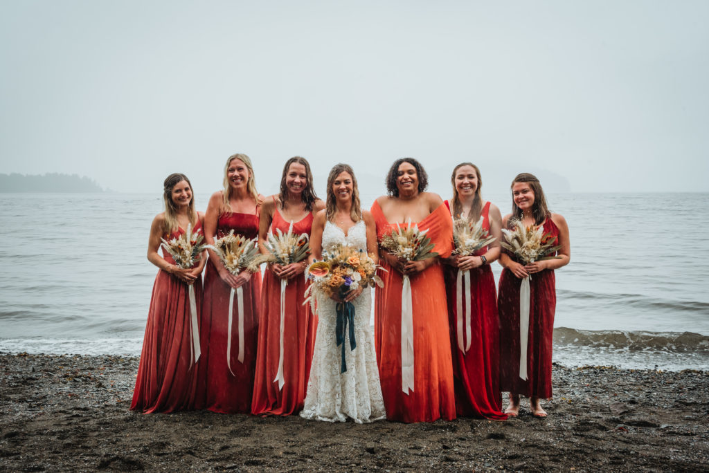 bride and bridesmaids in the pouring rain