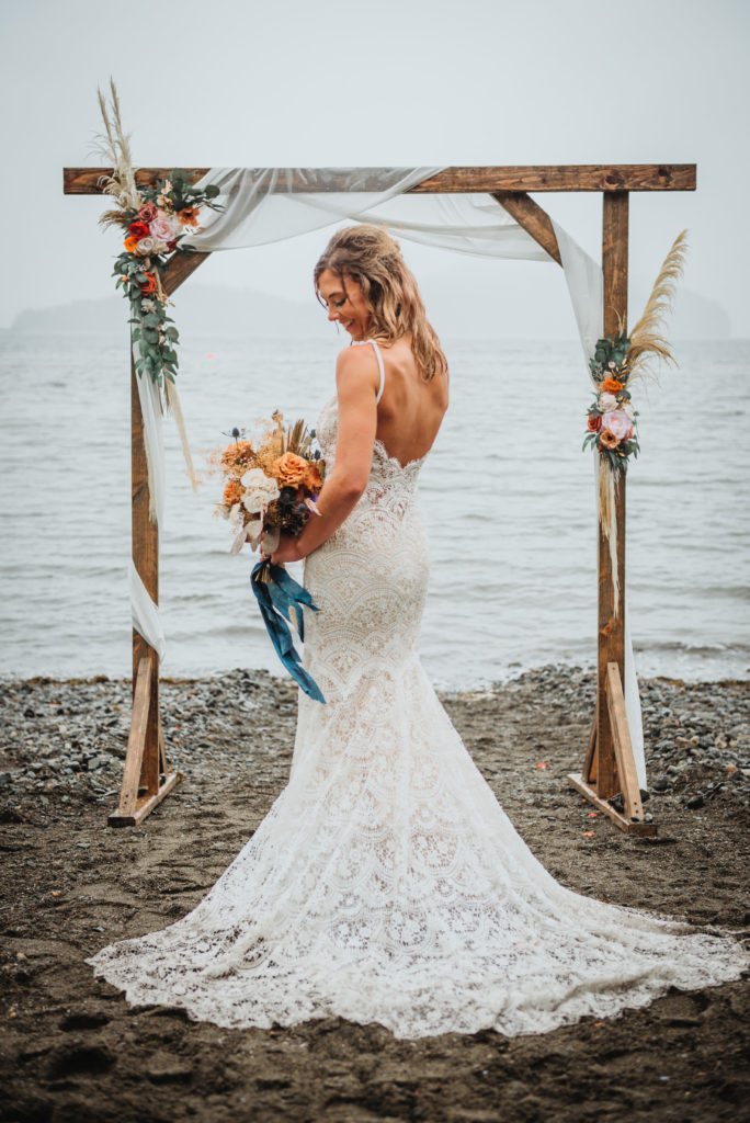 bridal portrait of bride and her wedding dress on an Alaska Beach