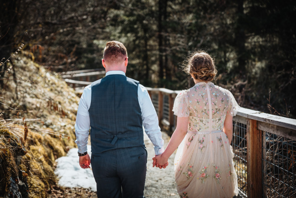 bride and groom walking trail at mendenhall glacier