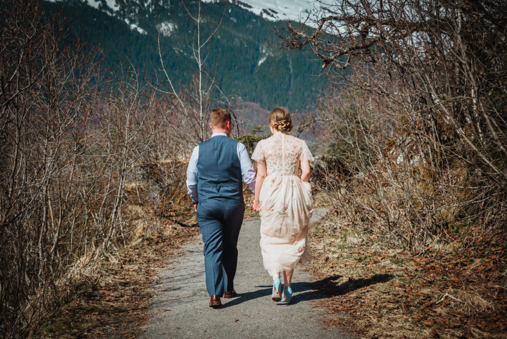 bride and groom walking to mendenhall glacier
