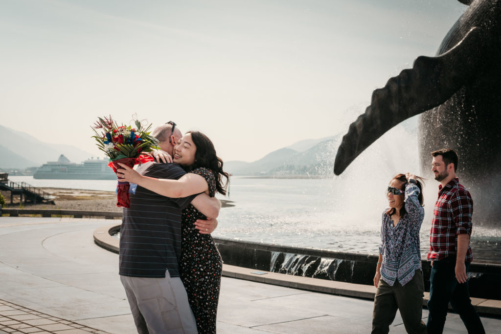 tyler surprises nikki with her parents at the whale statue in juneau alaska