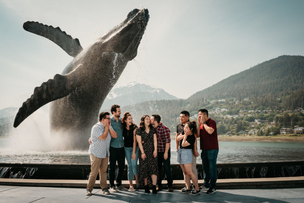 friends group photo at the whale statue in juneau alaska