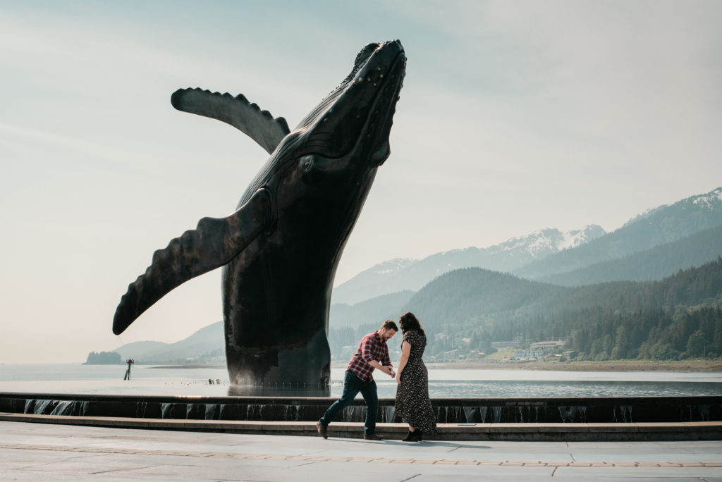 Tyler about to propose to nikki at the whale statue in juneau alaska