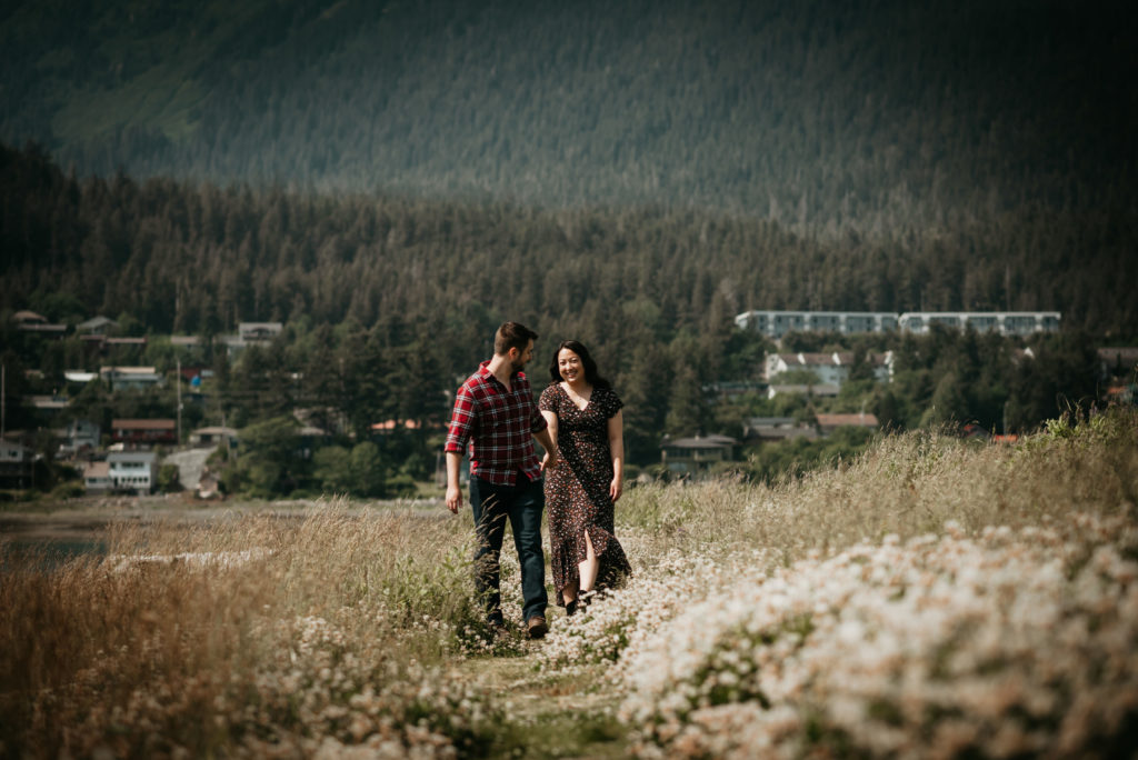 engaged couple walks through flower fields in downtown juneau alaska
