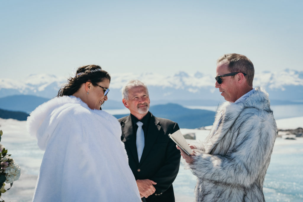 groom reading vows during alaska glacier wedding