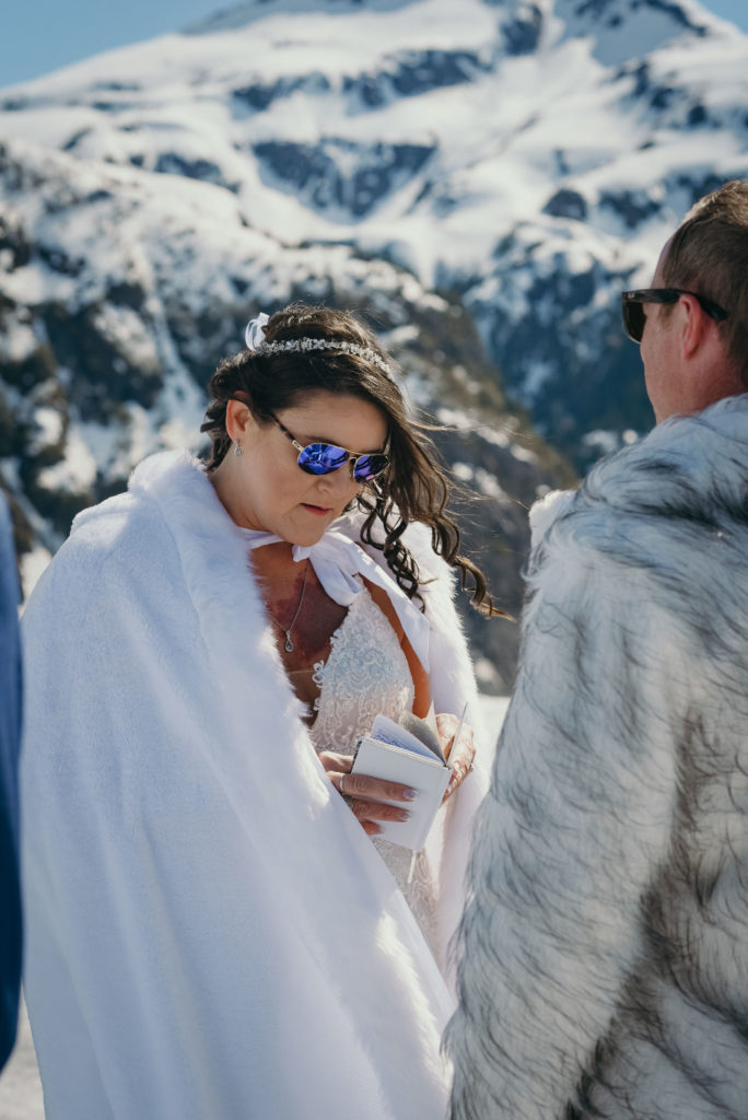 bride reading vows during alaska glacier wedding
