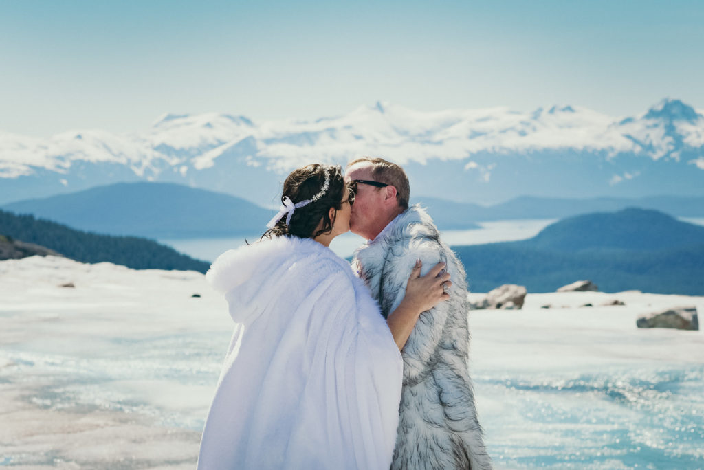 bride and groom's first kiss during alaska glacier wedding