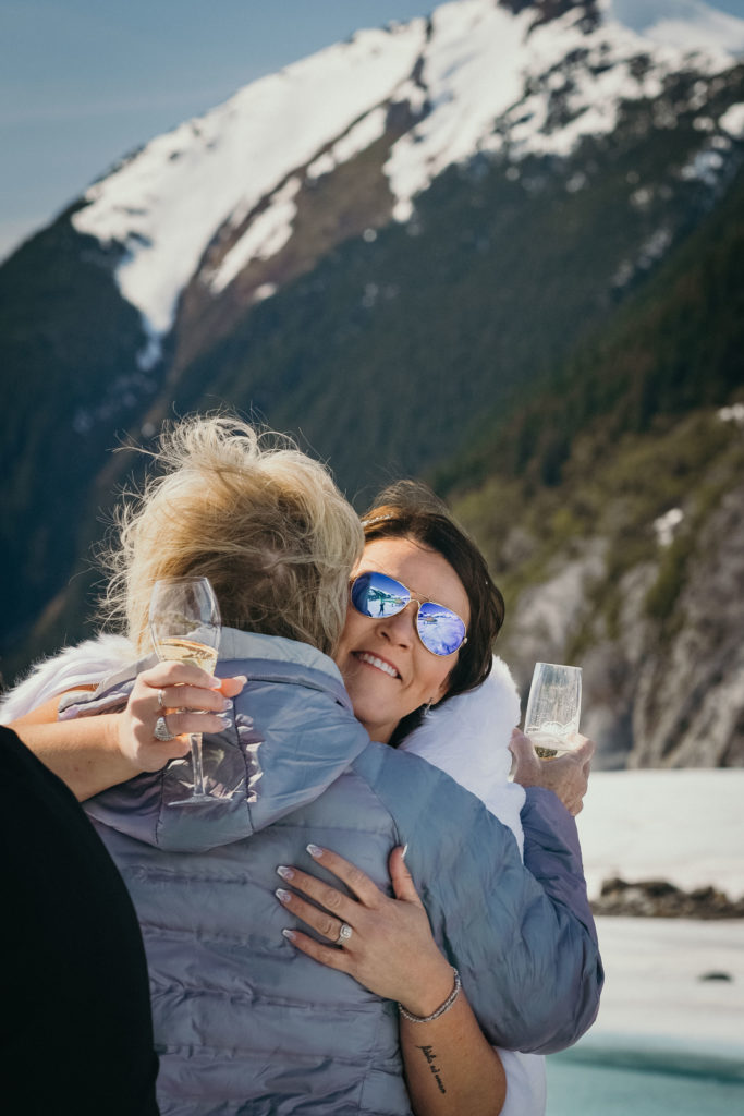 bride hugging mom on glacier
