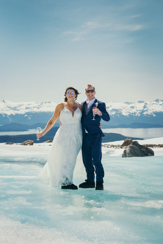 bride and groom drinking water from glacier stream