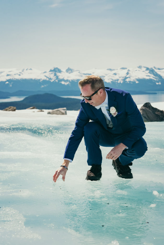 groom collecting water from a glacier stream