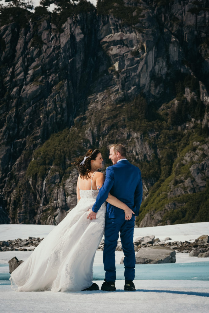 bride and groom grabbing butts on glacier