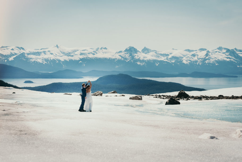 bride and groom dancing on herbert glacier with beautiful background