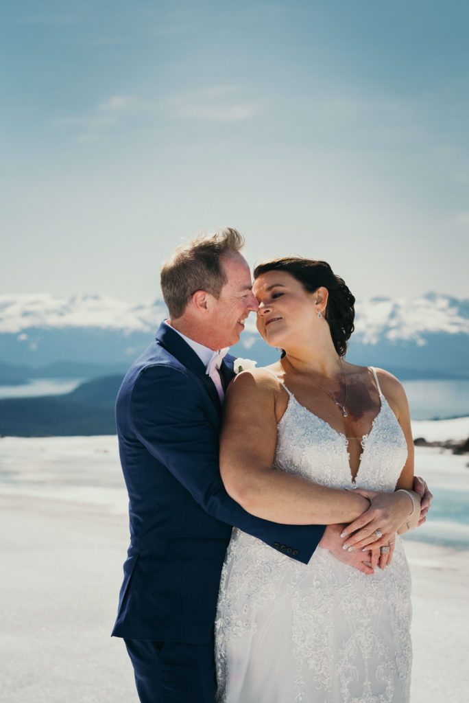 bride and groom on alaska glacier