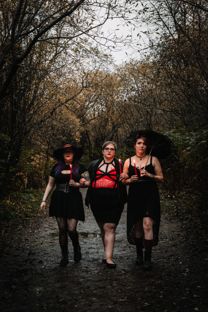 three witches walking on trail during styled shoot