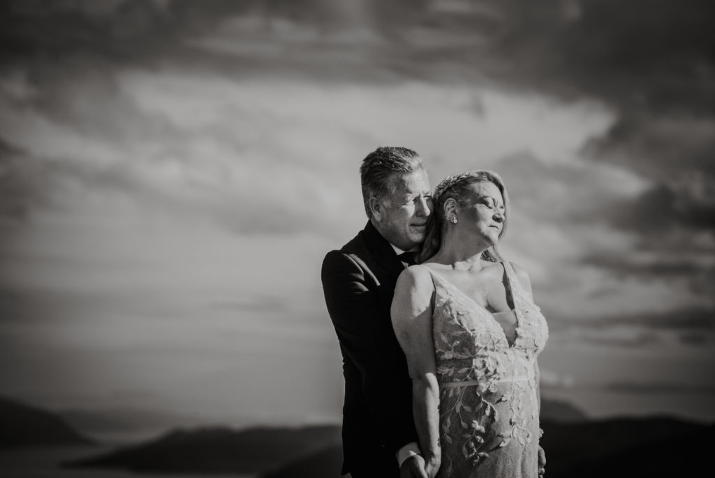 bride and groom in the clouds in juneau alaska