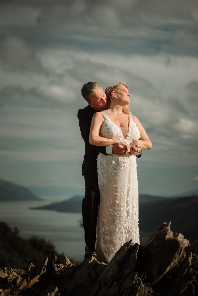 bride and groom in the clouds on mountaintop