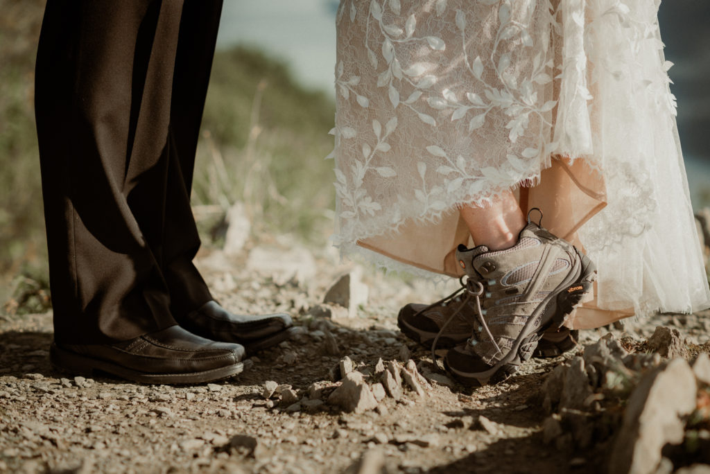 bride and groom kissing and bride in hiking boots