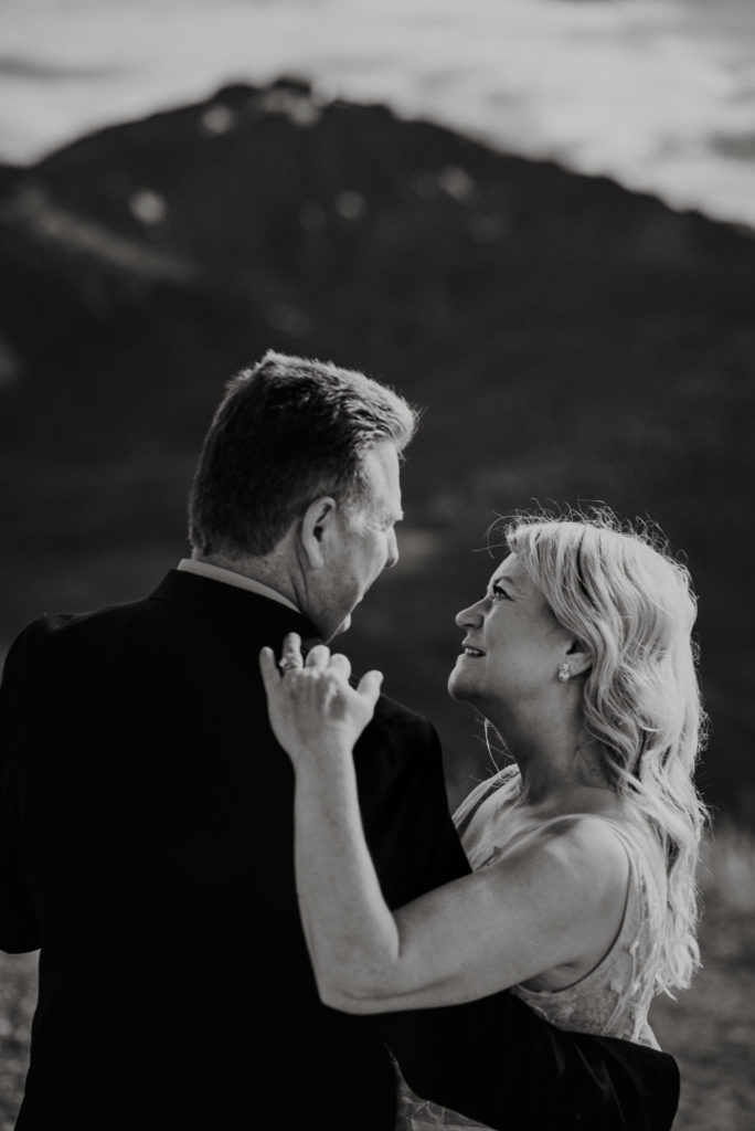 black and white portrait of bride and groom on alaska mountaintop