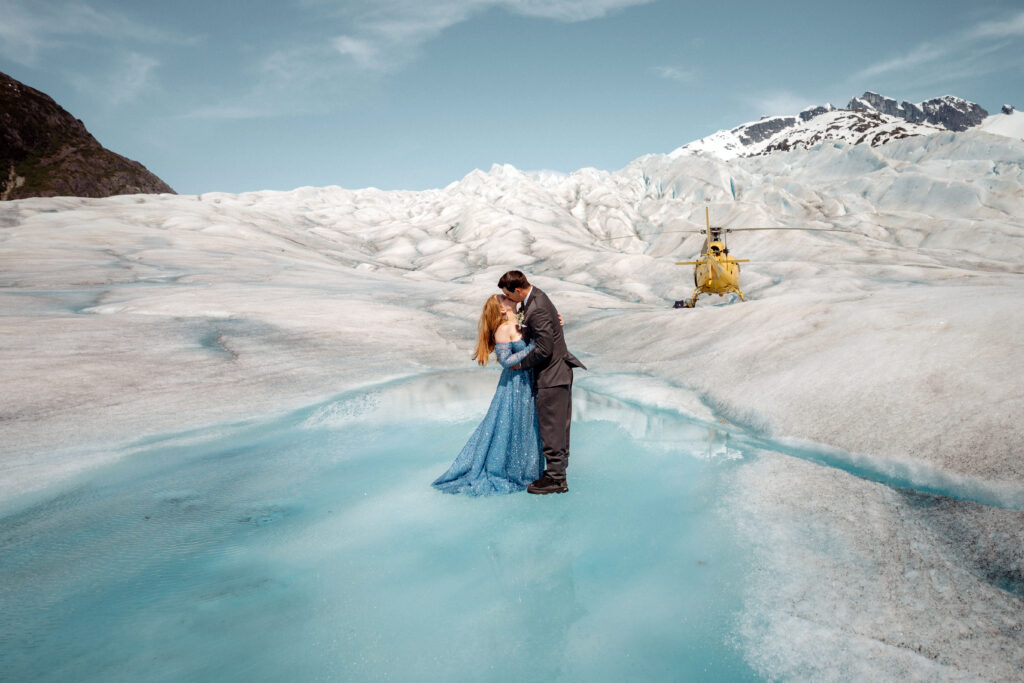 bride and groom eloping on a blue ice pool on the herbert glacier in juneau alaska