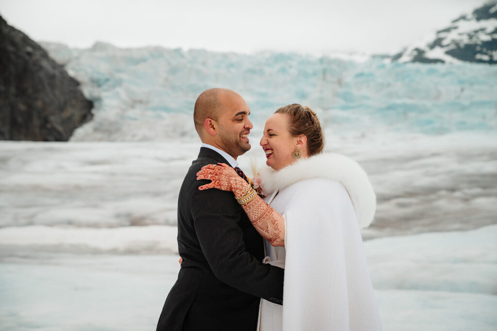 Couple exchanging vows on Mendenhall Glacier during Alaska elopement ceremony